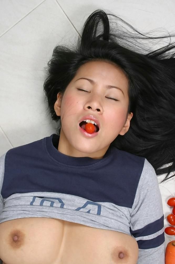 Asian plays with veggies in kitchen - part 2446 page 1