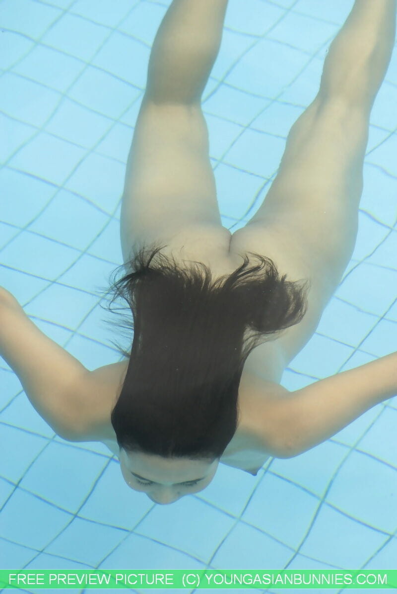 Young Asian girl with firm tits and a full bush swims naked in a pool page 1