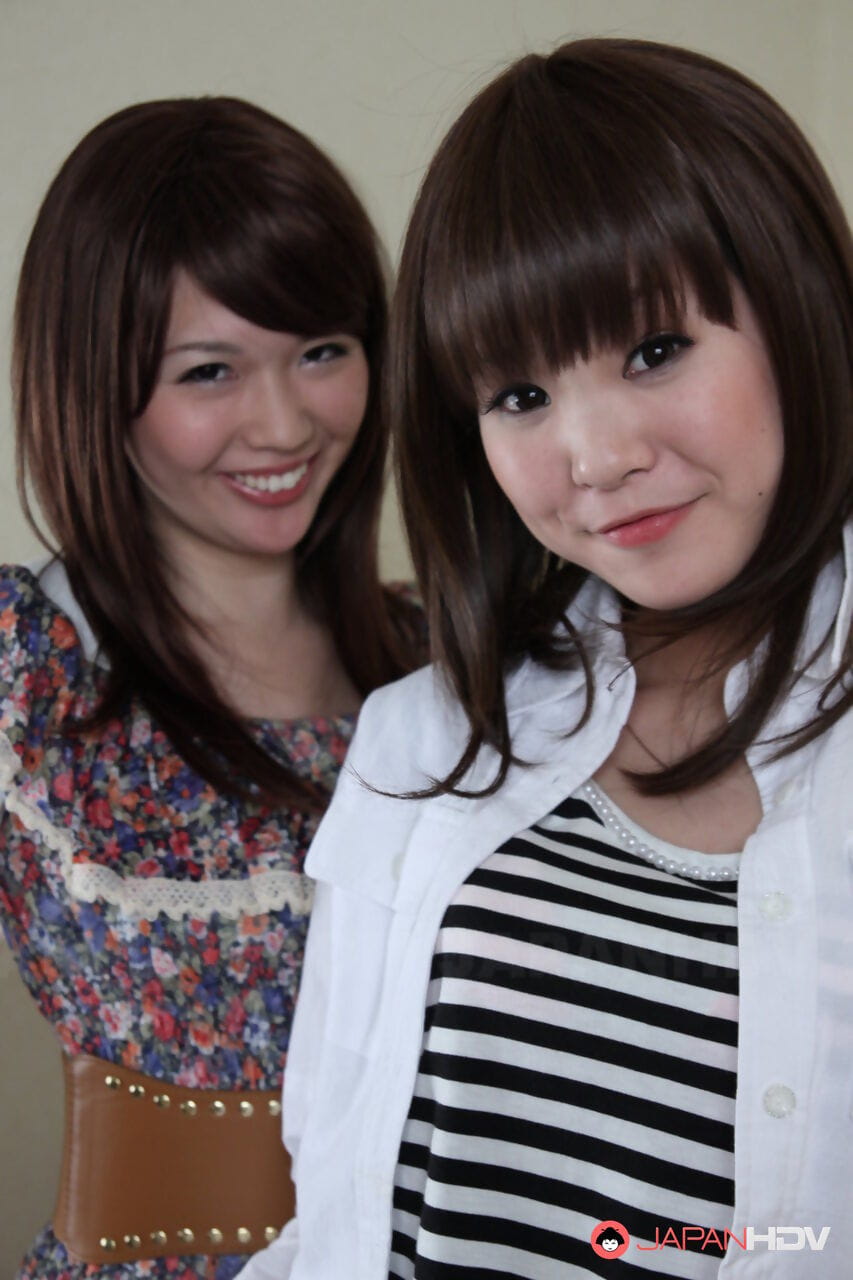 Japanese lesbians Rimu Endo & Ueno Misaki uncovers small tits as they disrobe page 1