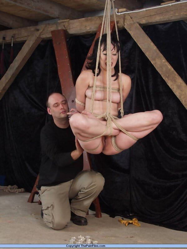 Asian female endures tit torture while suspended by ropes in the nude page 1