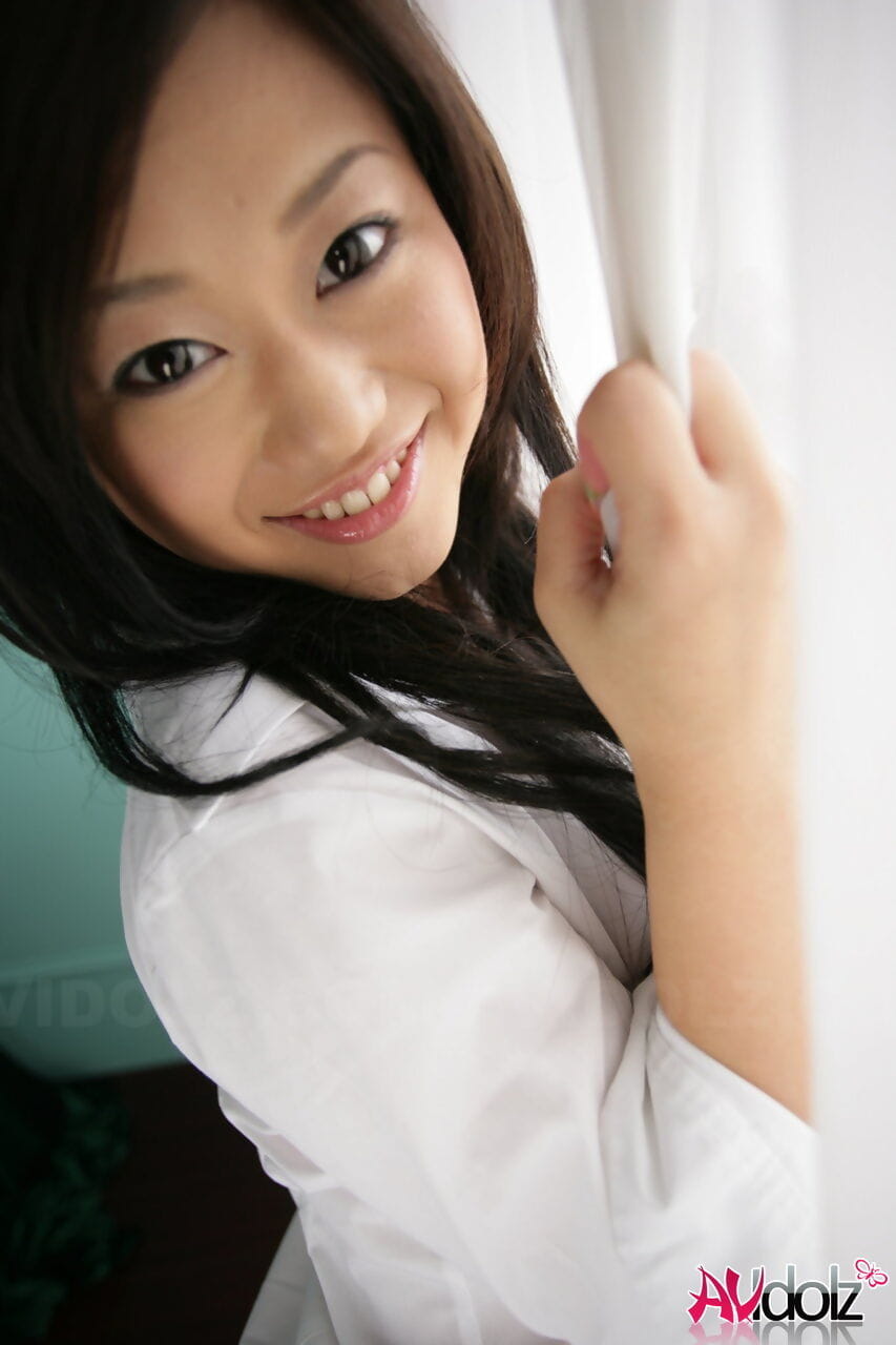 Cute Japanese teen Minako Oyama exposes her bra and panty set upon her bed page 1