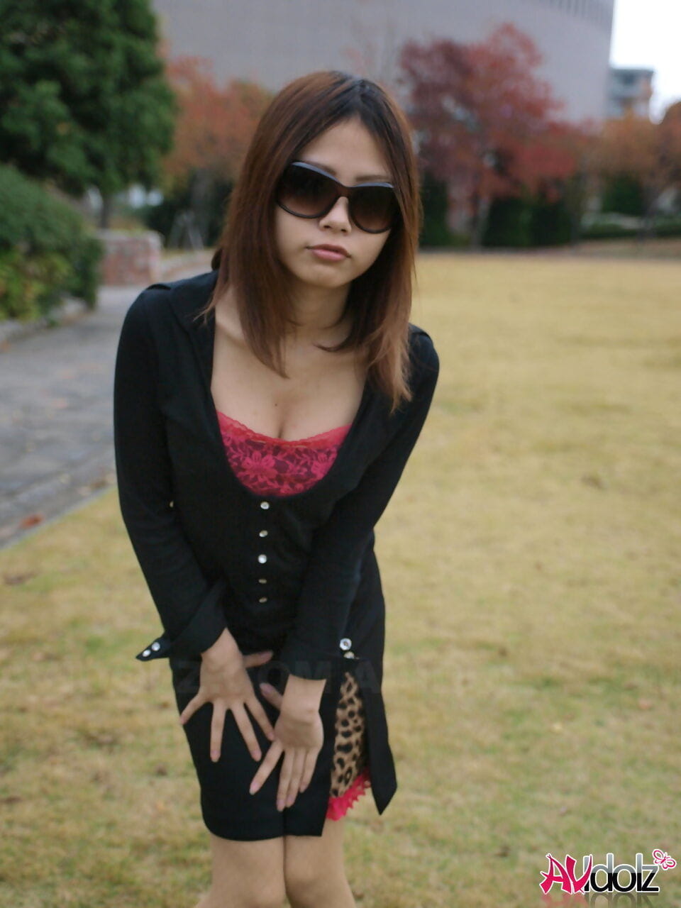 Fully clothed Japanese girl lifts up sunglasses to show her pretty face page 1