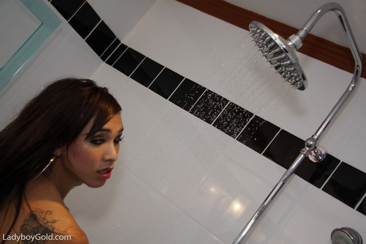 Nasty Asian ladyboy jerking her stiff dick while having solo fun under shower page 1