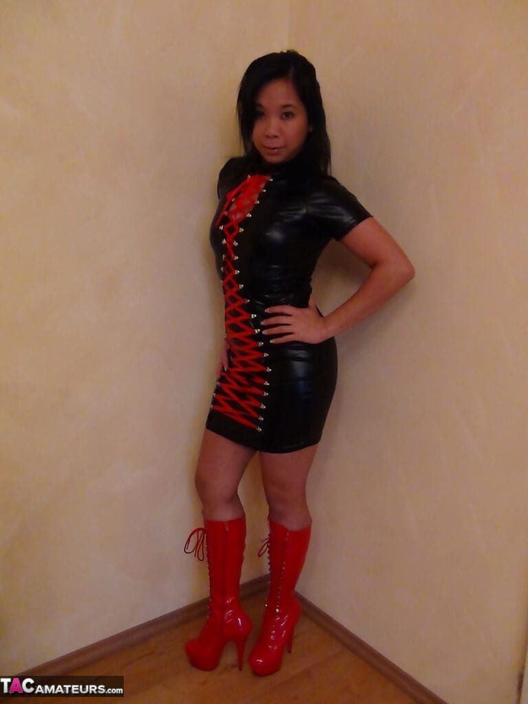 Beautiful Asian female in hot latex and high heel boots flashes sexy upskirt page 1