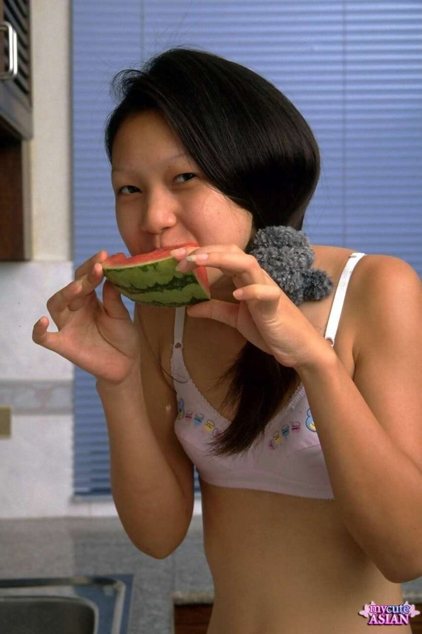 Petite Asian girl spreads her tight pussy after eating watermelon page 1