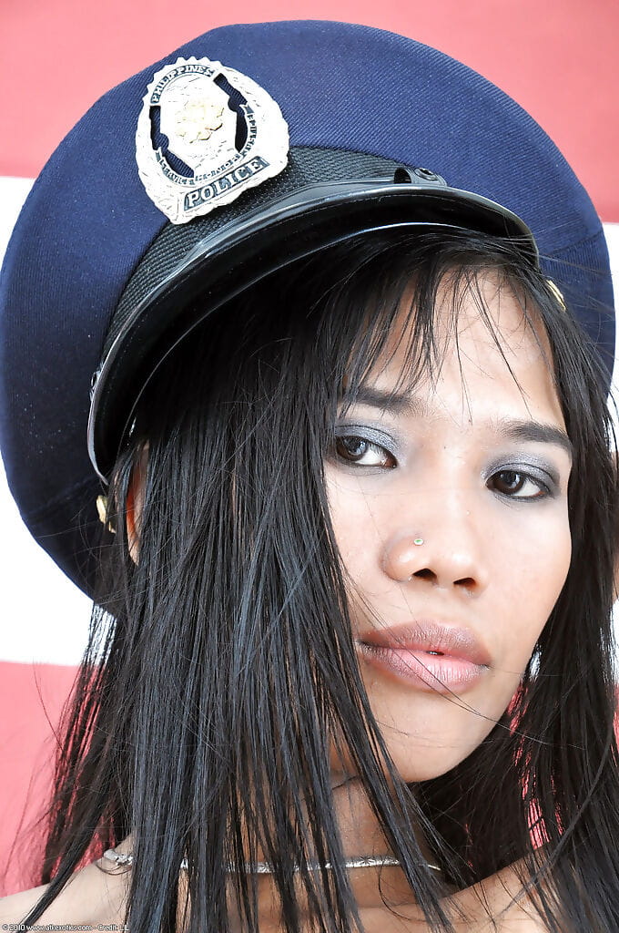Gorgeous amateur Asian Anne poses in the amazing police uniform page 1
