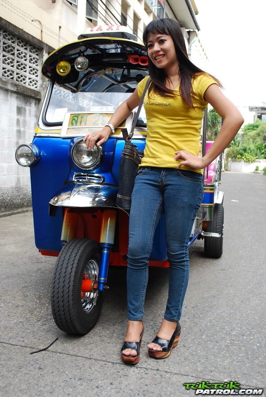 Female Tuk Tuk driver and a Farang ham it up for the camera in a back alley page 1