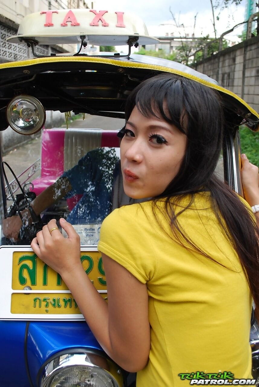 Female Tuk Tuk driver and a Farang ham it up for the camera in a back alley page 1