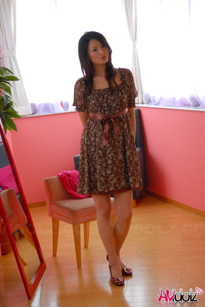 Japanese teen with a pretty face shows her legs in a short dress and heels page 1
