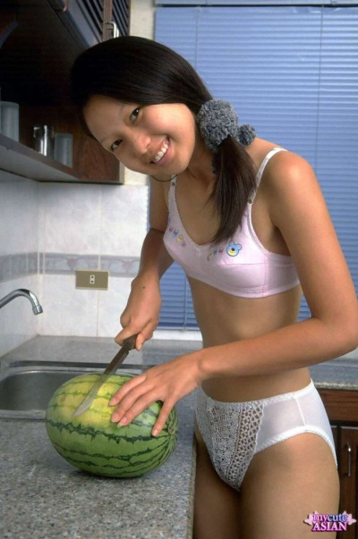 Petite Asian girl spreads her tight pussy after eating watermelon
