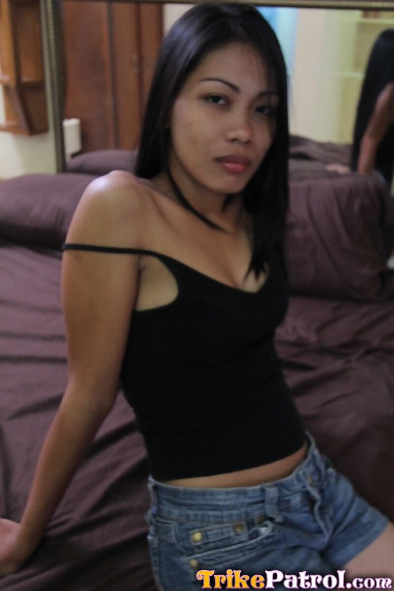 Filipina prostitute Analyn strips naked on a motel bed for a sex tourist page 1