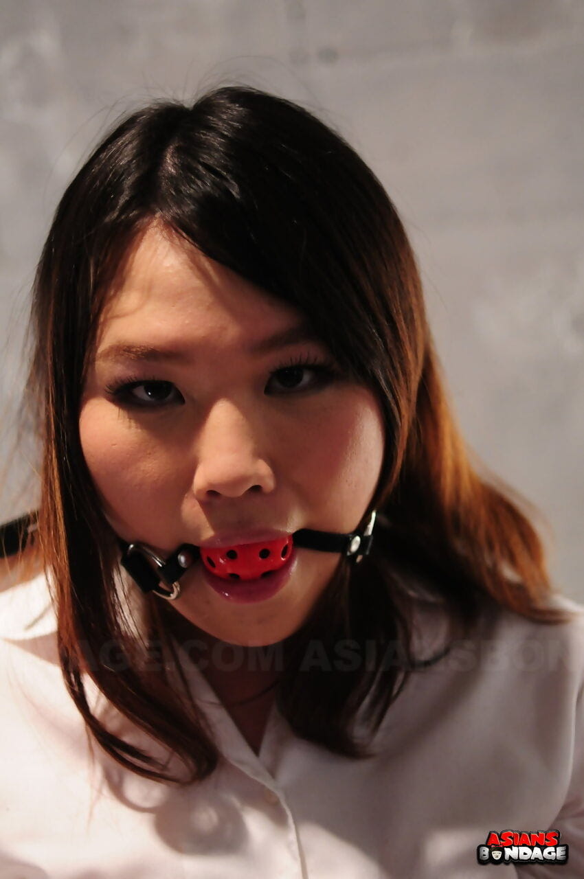 Asian chick Aki Sasahara is fitted with gag in white blouse and black skirt page 1