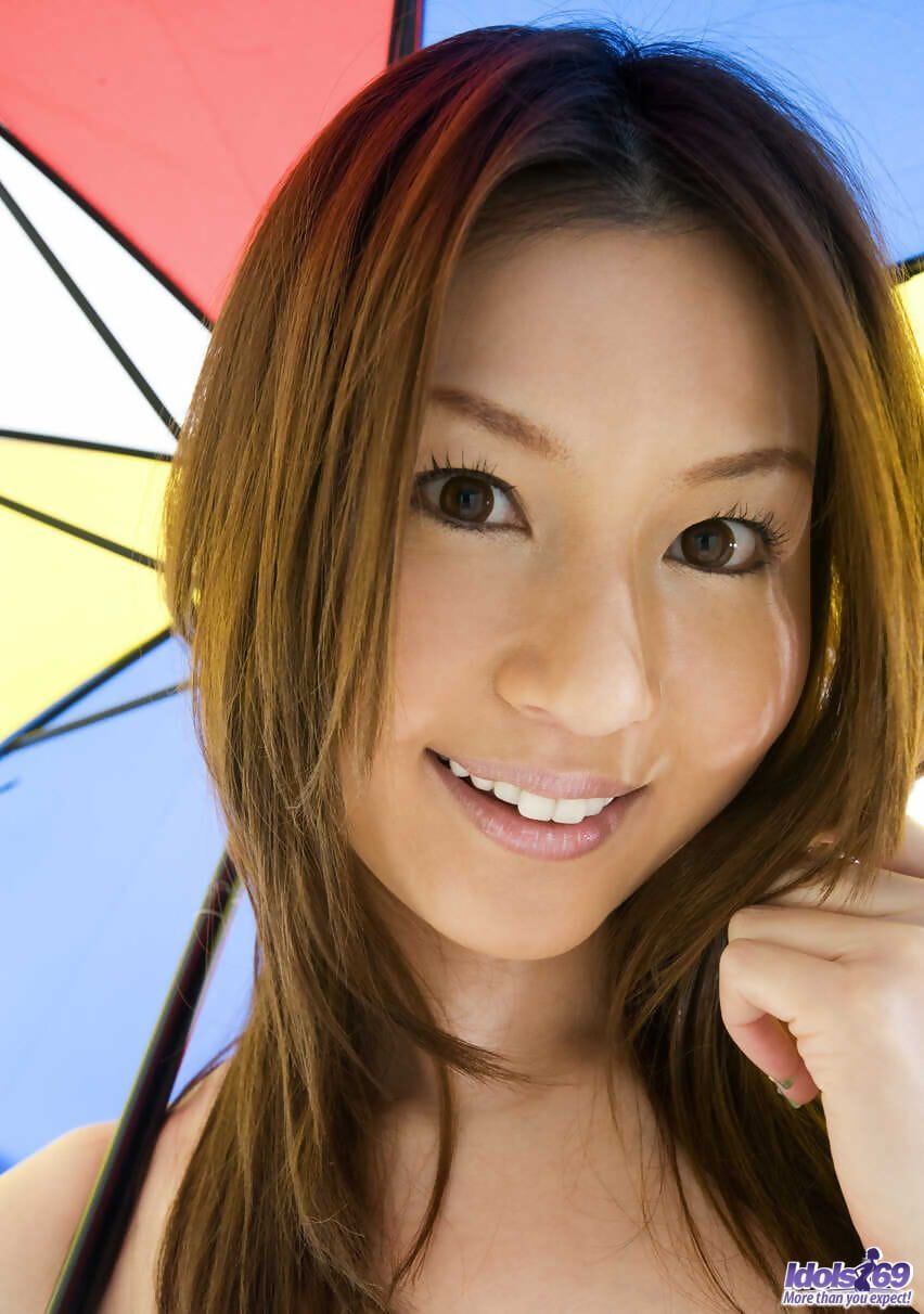 Sexy Japanese girl Tatsumi Yui holds an umbrella while standing naked page 1
