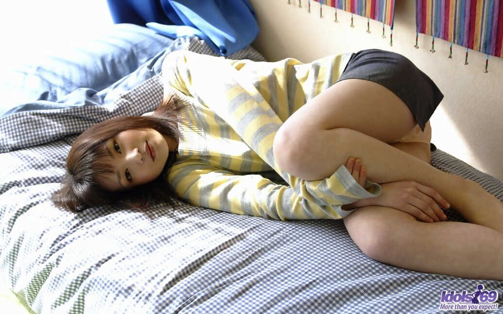 Young Japanese girl Kanan Kawaii flashes upskirt panties before getting naked page 1